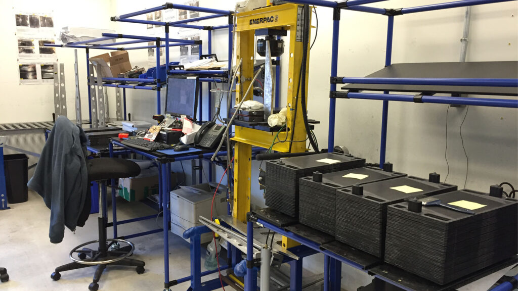 Assembly workstation in a production environment built from modular coated steel tube and connector framing